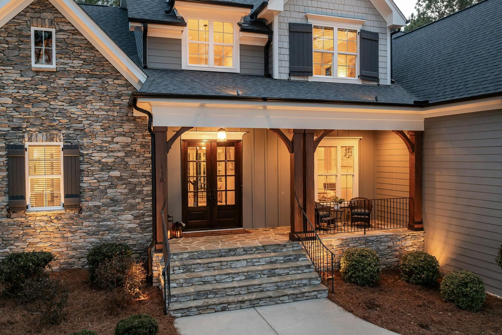 Inviting front door entry with manicured landscaping illustrating strong curb appeal.