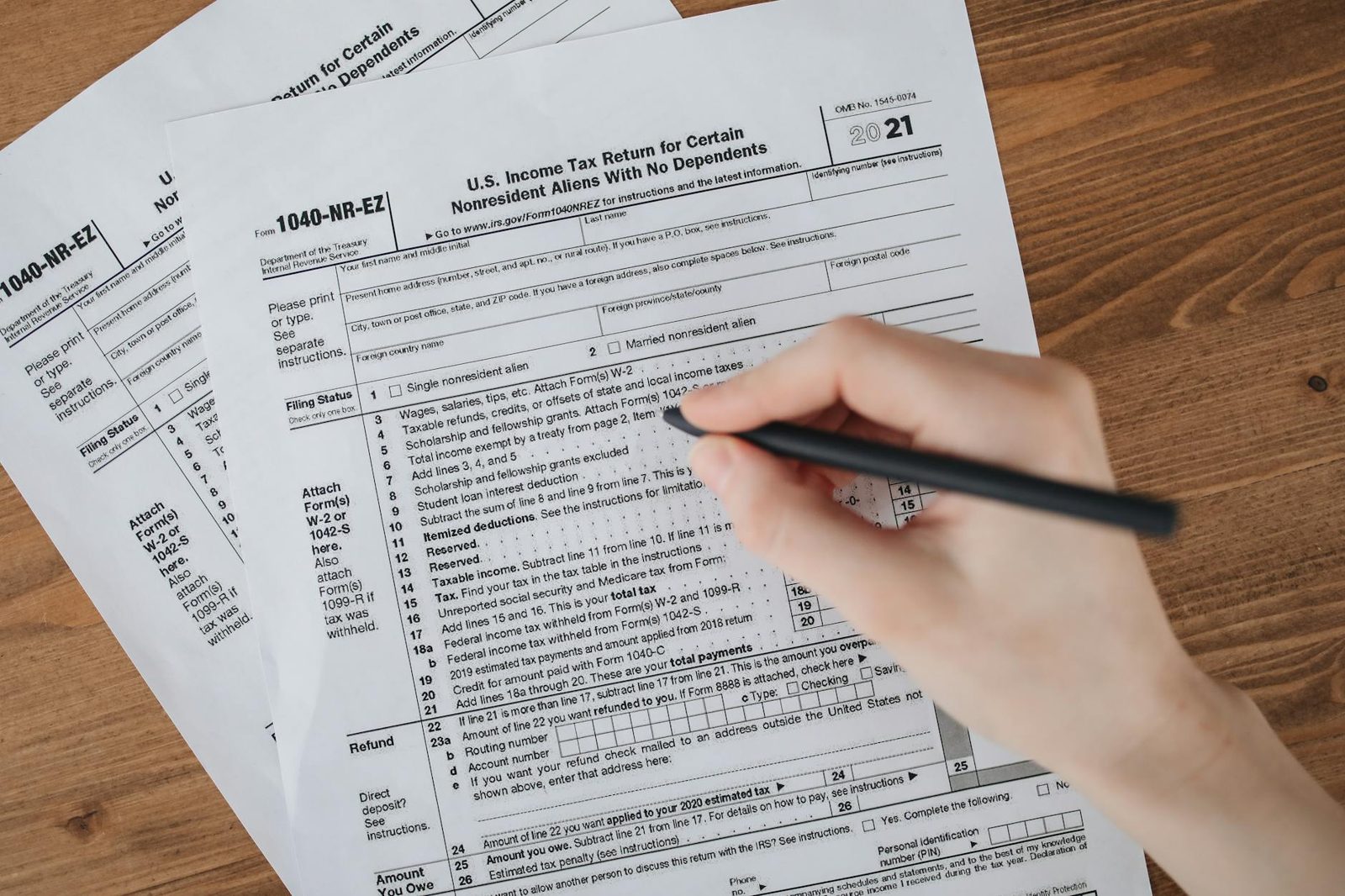 Tax returns and 1099 forms spread on a desk — the income documentation lenders rely on.