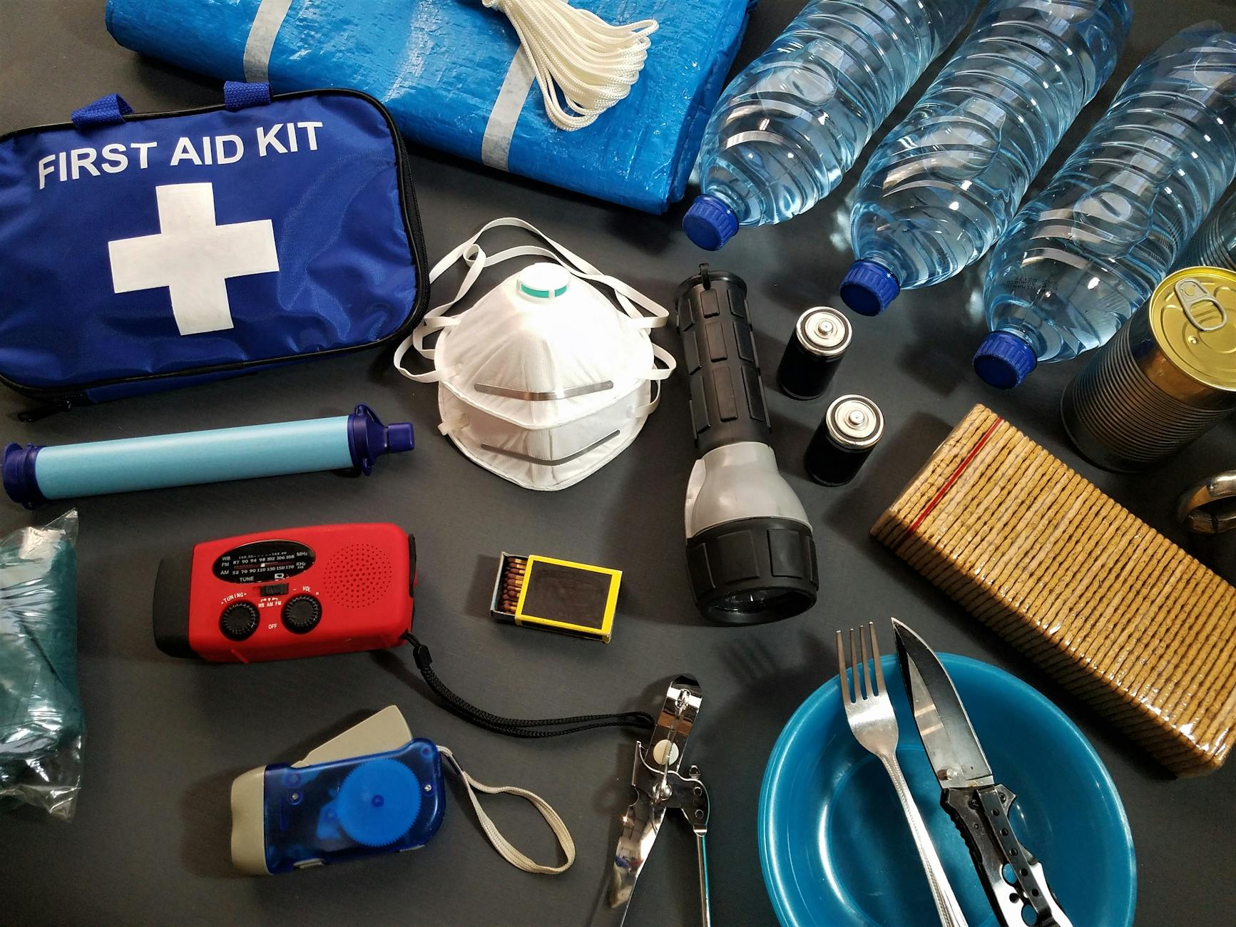 Hurricane emergency supply kit with water, batteries, flashlights, and food.