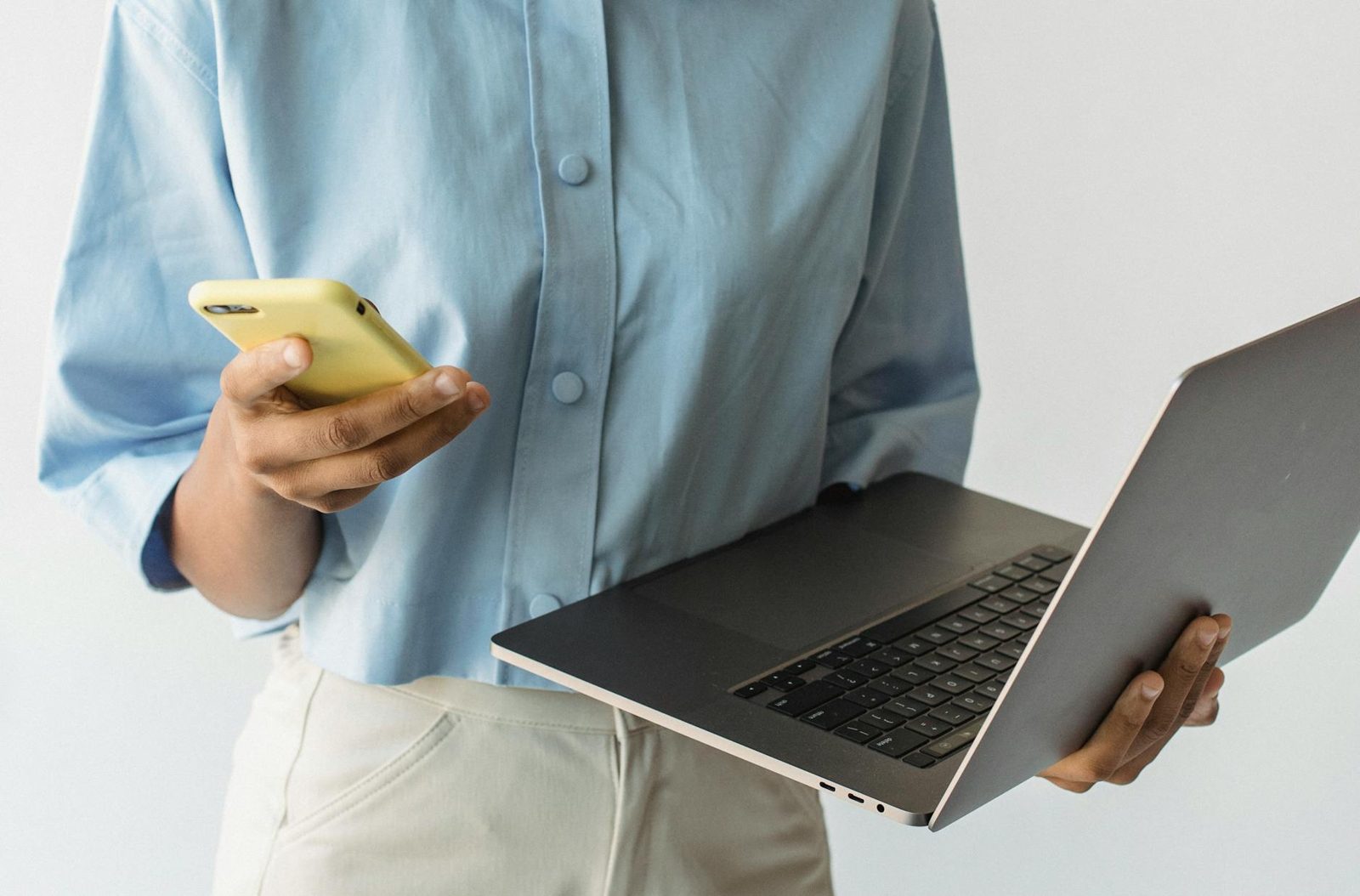 Person on the phone comparing quotes at a laptop — shopping title insurance, settlement, and homeowners insurance saves real money.