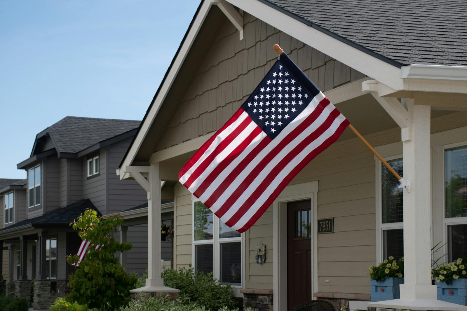 Veteran family in front of their new home financed with a VA loan