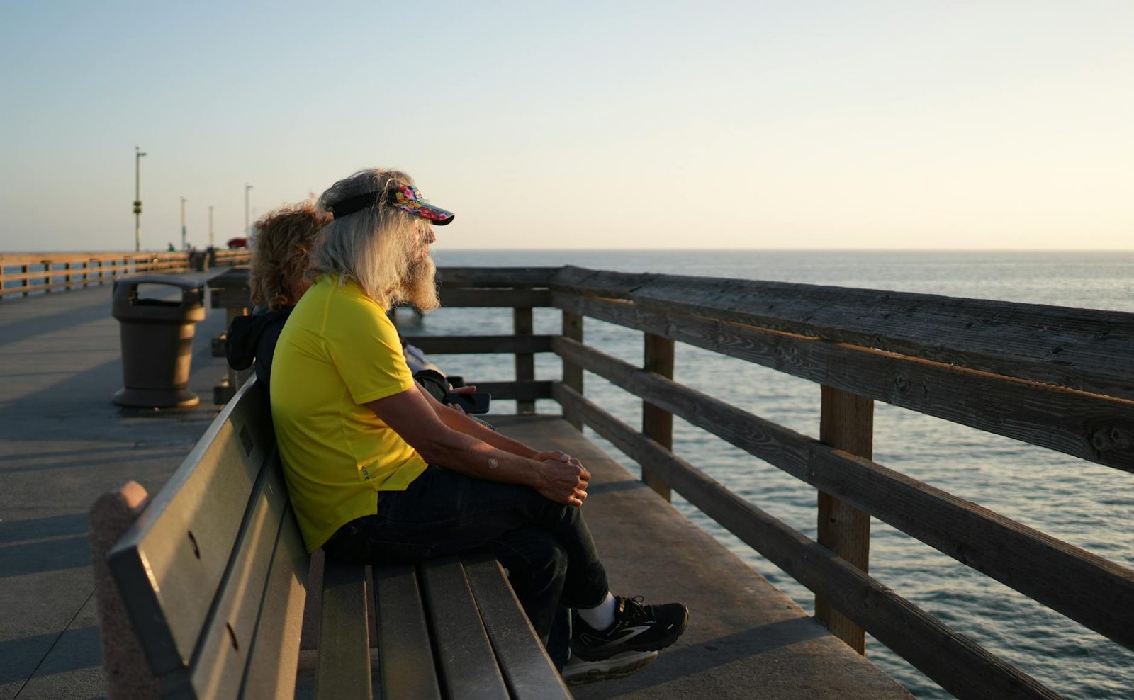 Couple watching the sunset from a coastal pier in southeastern North Carolina.