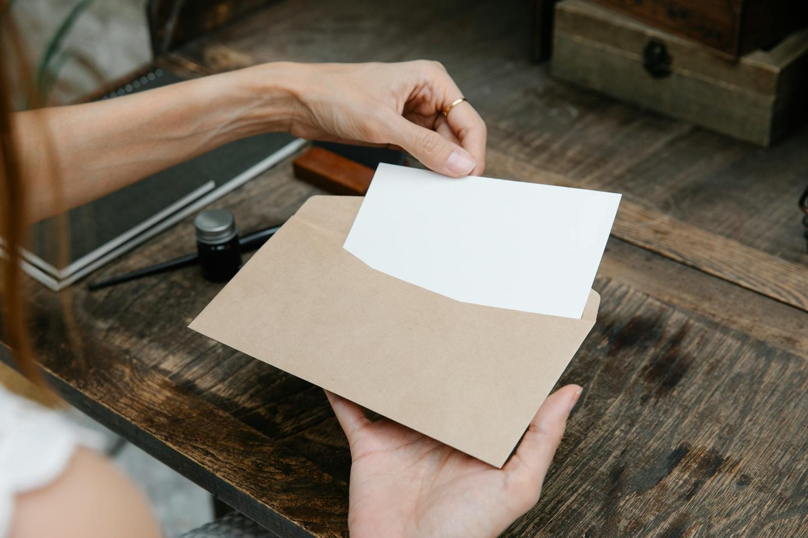 A pre-approval letter being handed across a desk — the letter is the outcome of the document set, not the start.