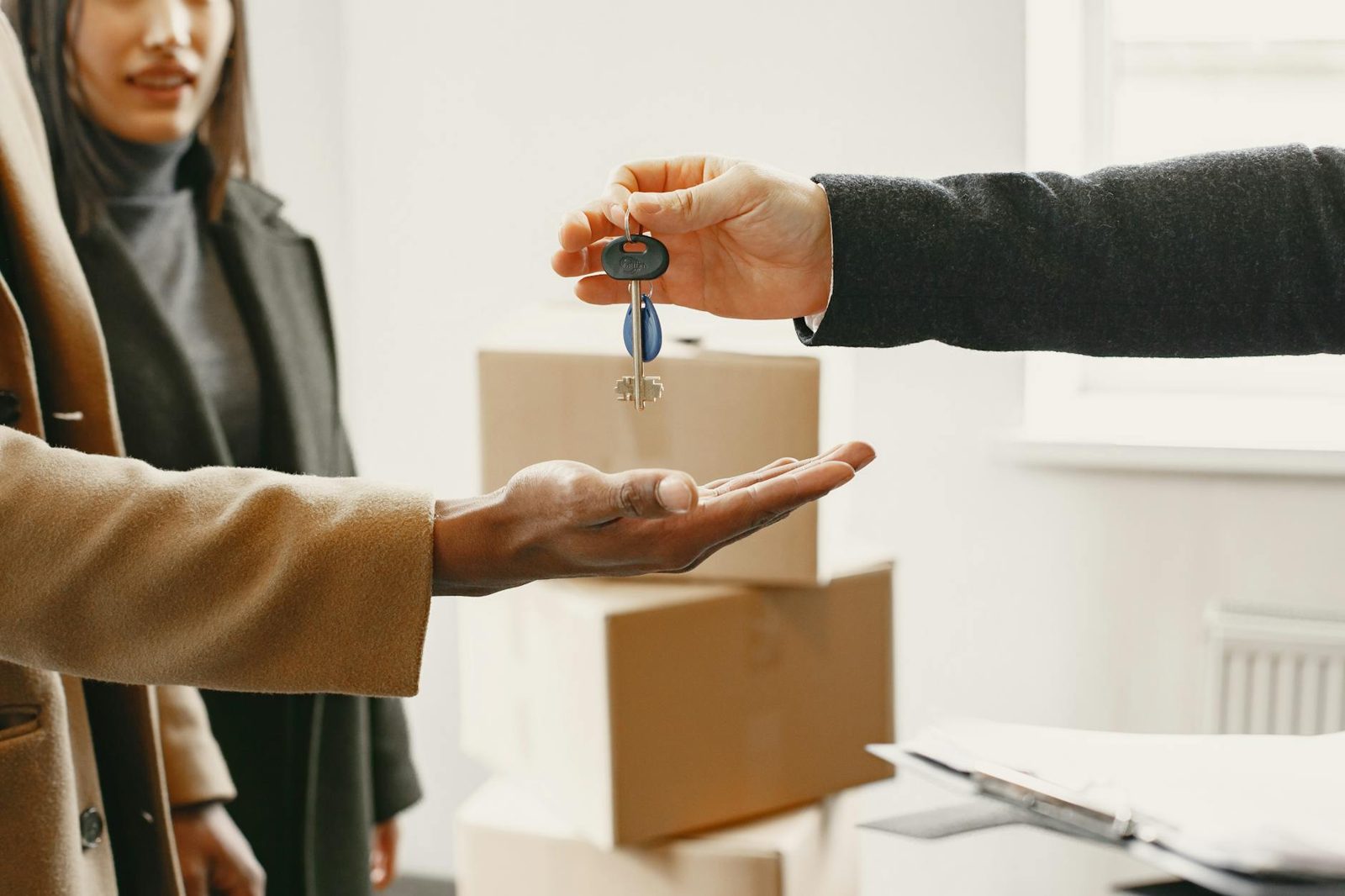 Handover of keys to a new home buyer at the end of a successful 90-day close.