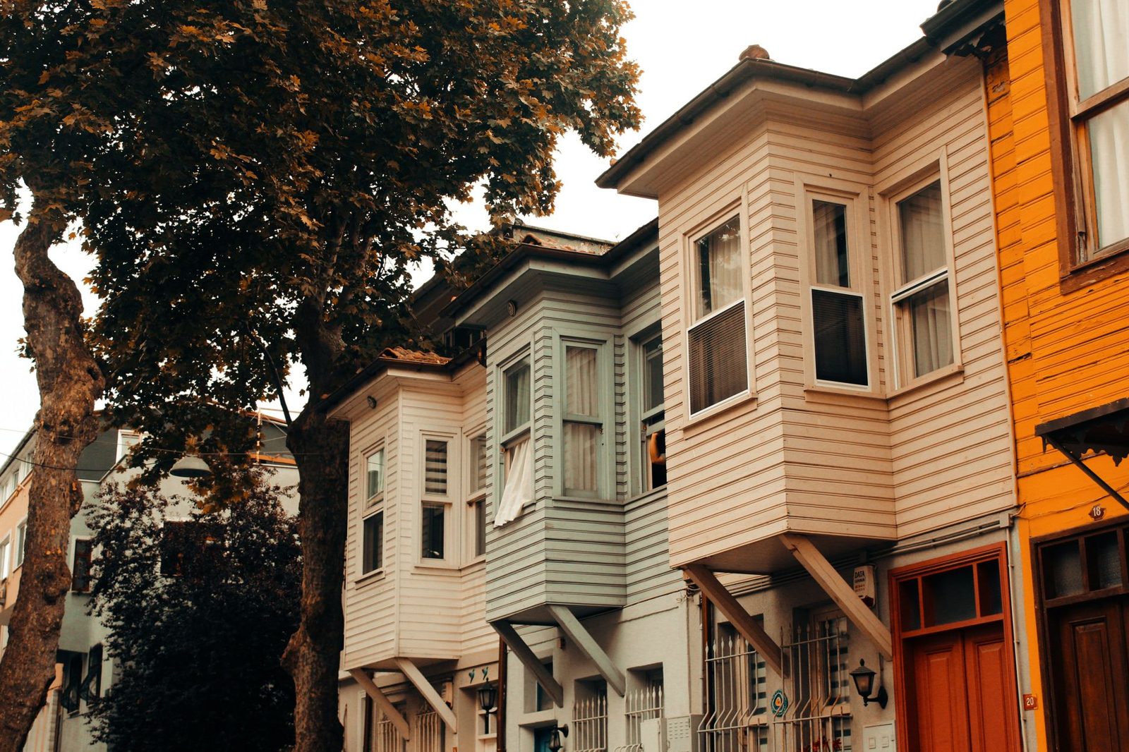 Older residential home exterior representing higher maintenance costs compared to newer construction