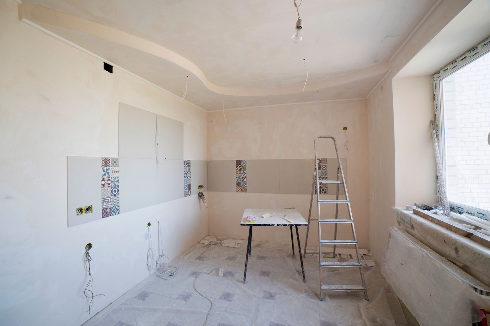 Modern kitchen renovation in progress with construction materials visible