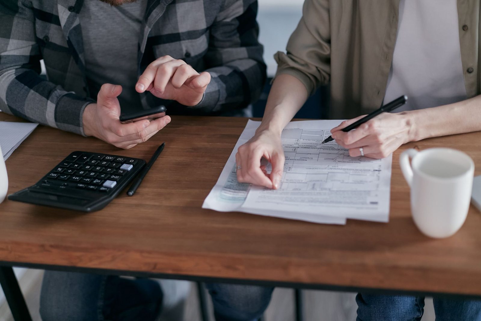 Property tax documents and a calculator on a desk — building the full carrying cost of a home.