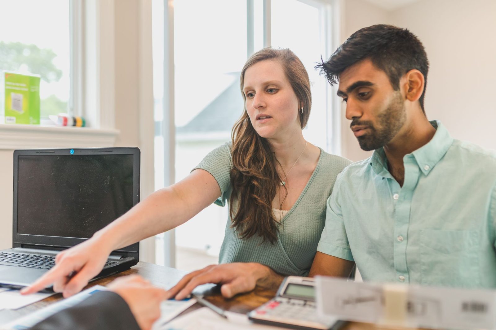 Young couple browsing real estate listings on a laptop