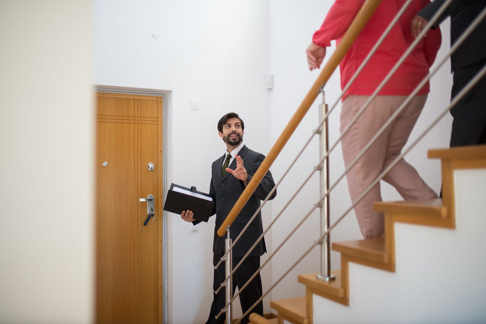 A real estate agent showing a home to buyers during a scheduled tour.
