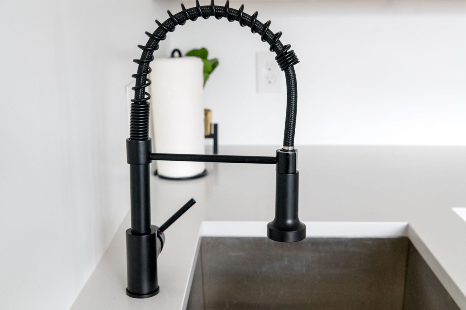 Kitchen with updated cabinet hardware and modern faucet fixture