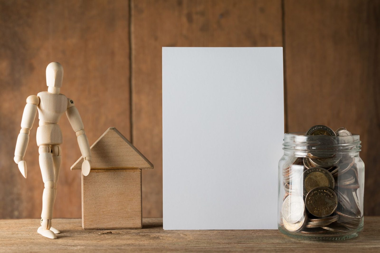 Savings concept with money in a jar labeled for home maintenance fund