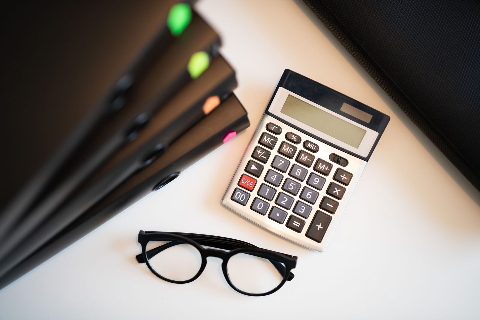 Financial documents and calculator comparing home loan numbers