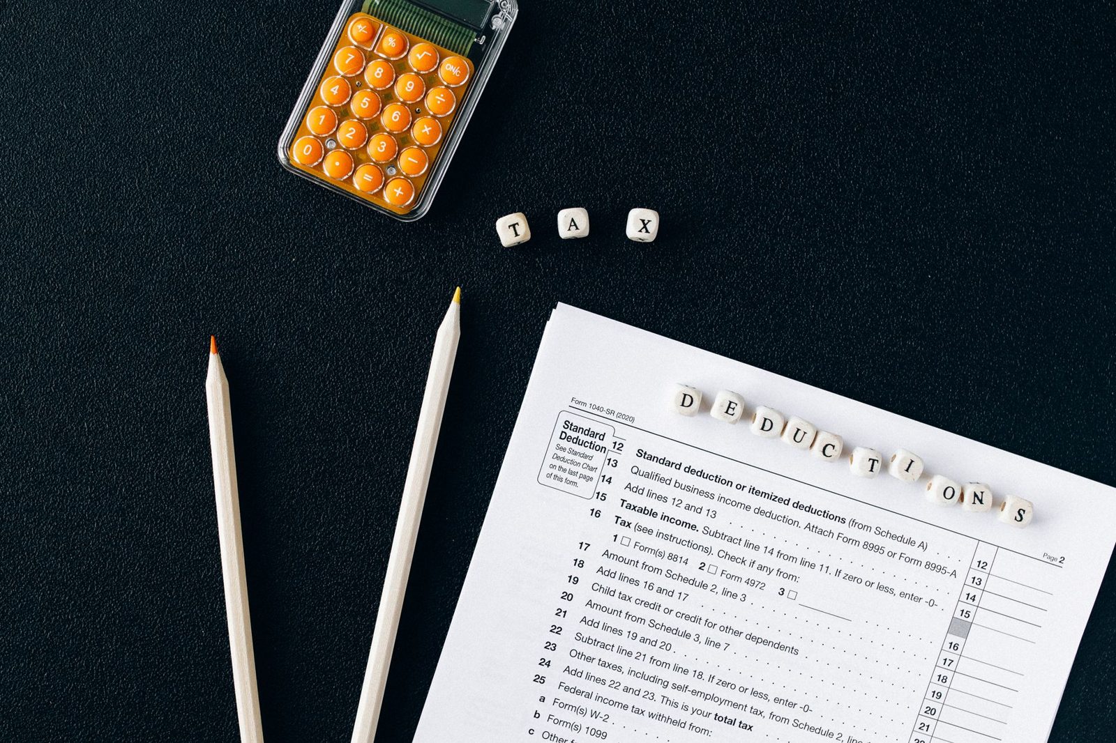 Calculator and pen on insurance documents showing deductible calculation