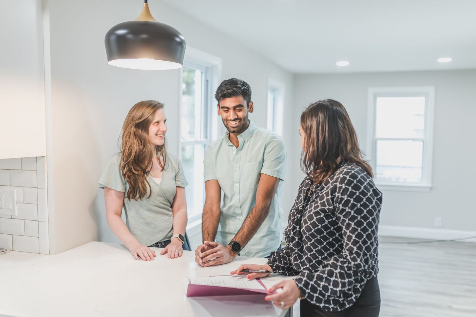Homebuyers discussing contingency options with their real estate agent