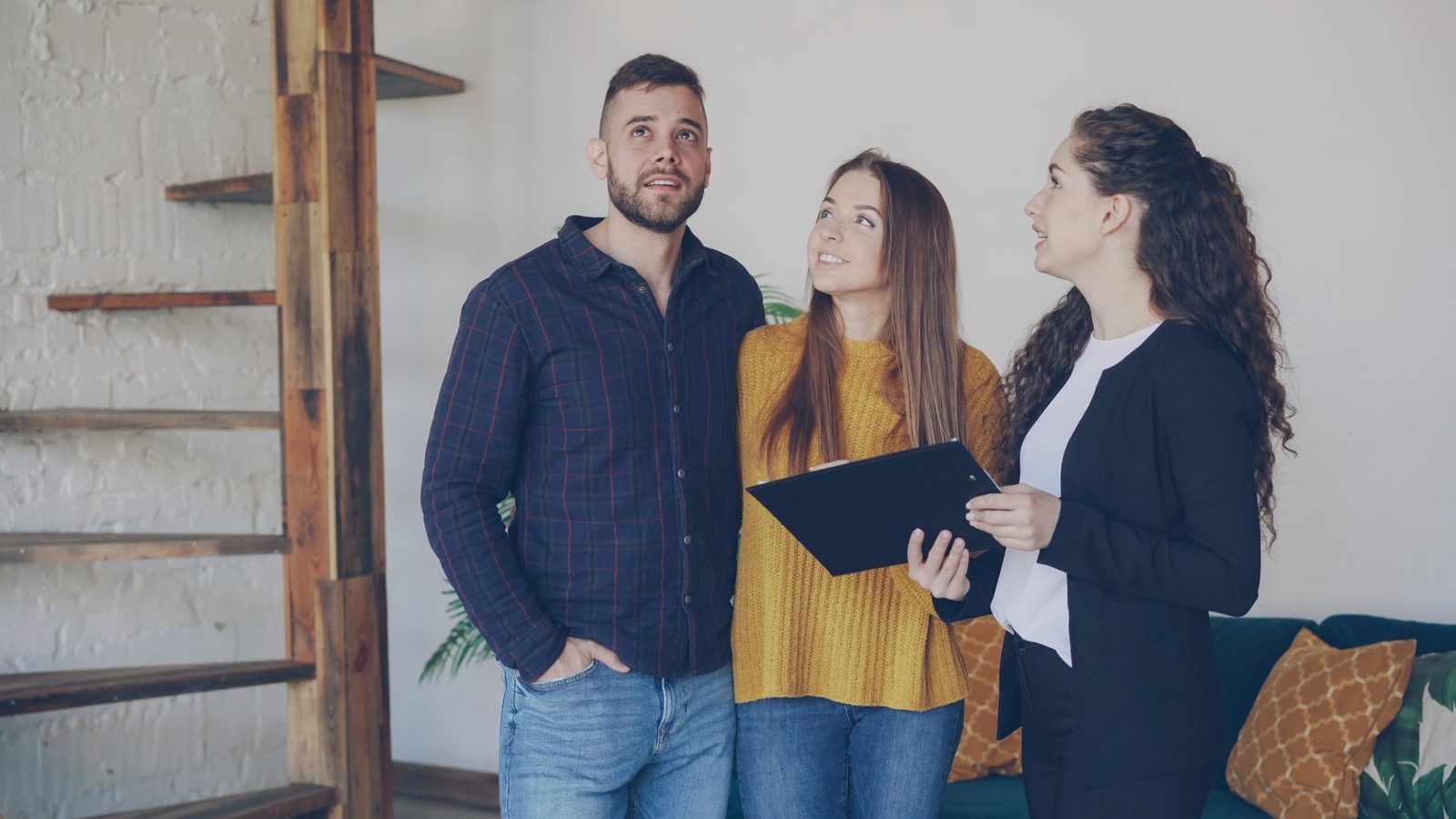 Real estate agent discussing options with a homebuying couple