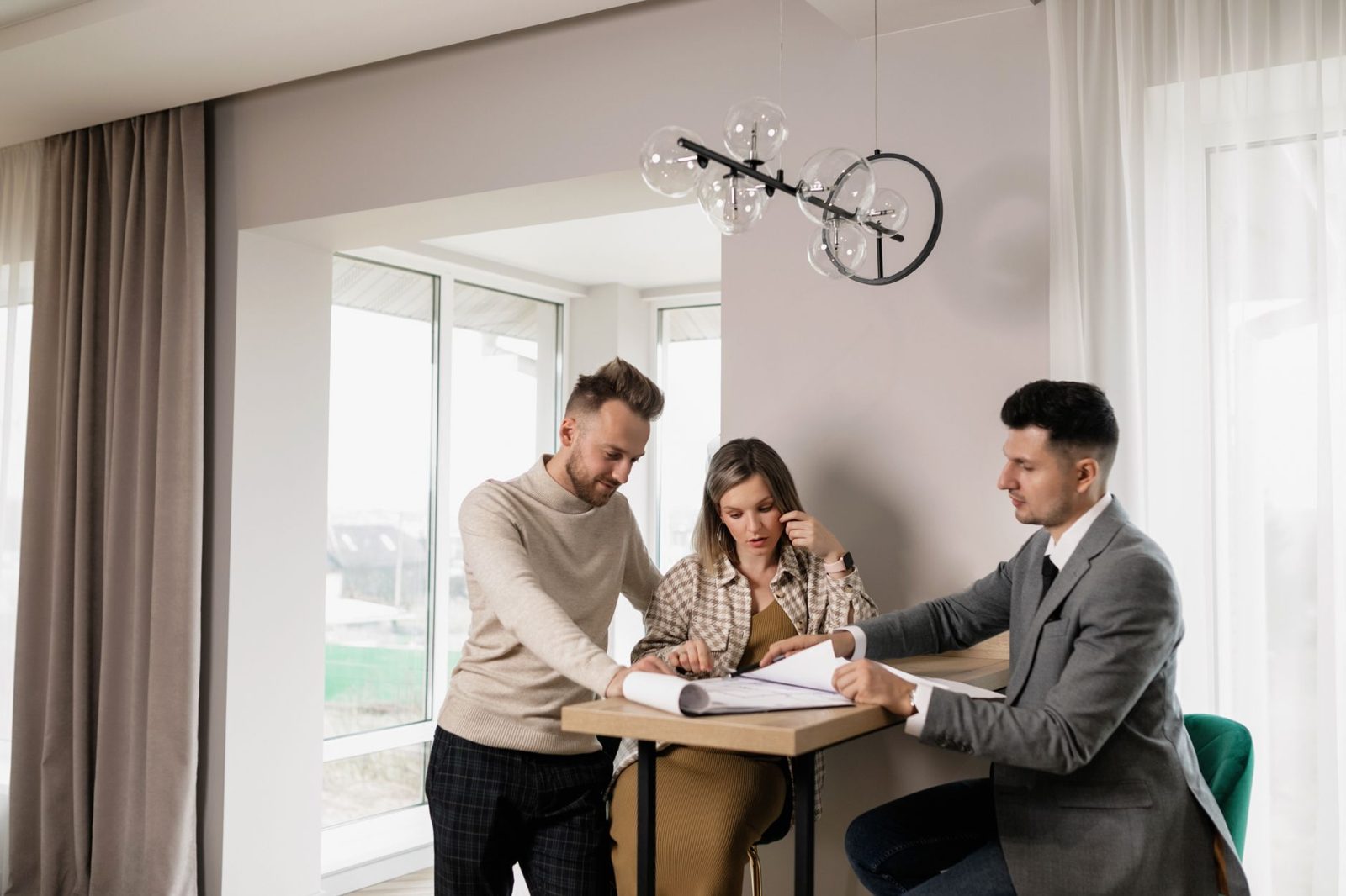 A homeowner reviewing real estate pricing data with their agent before listing.