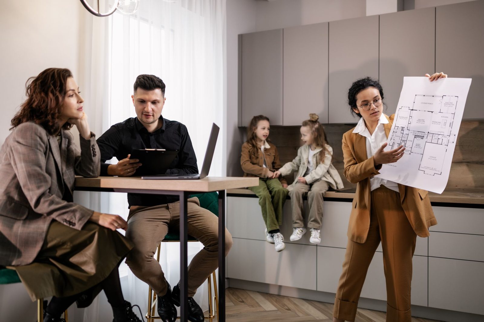 Real estate agent presenting a side-by-side offer comparison spreadsheet to clients