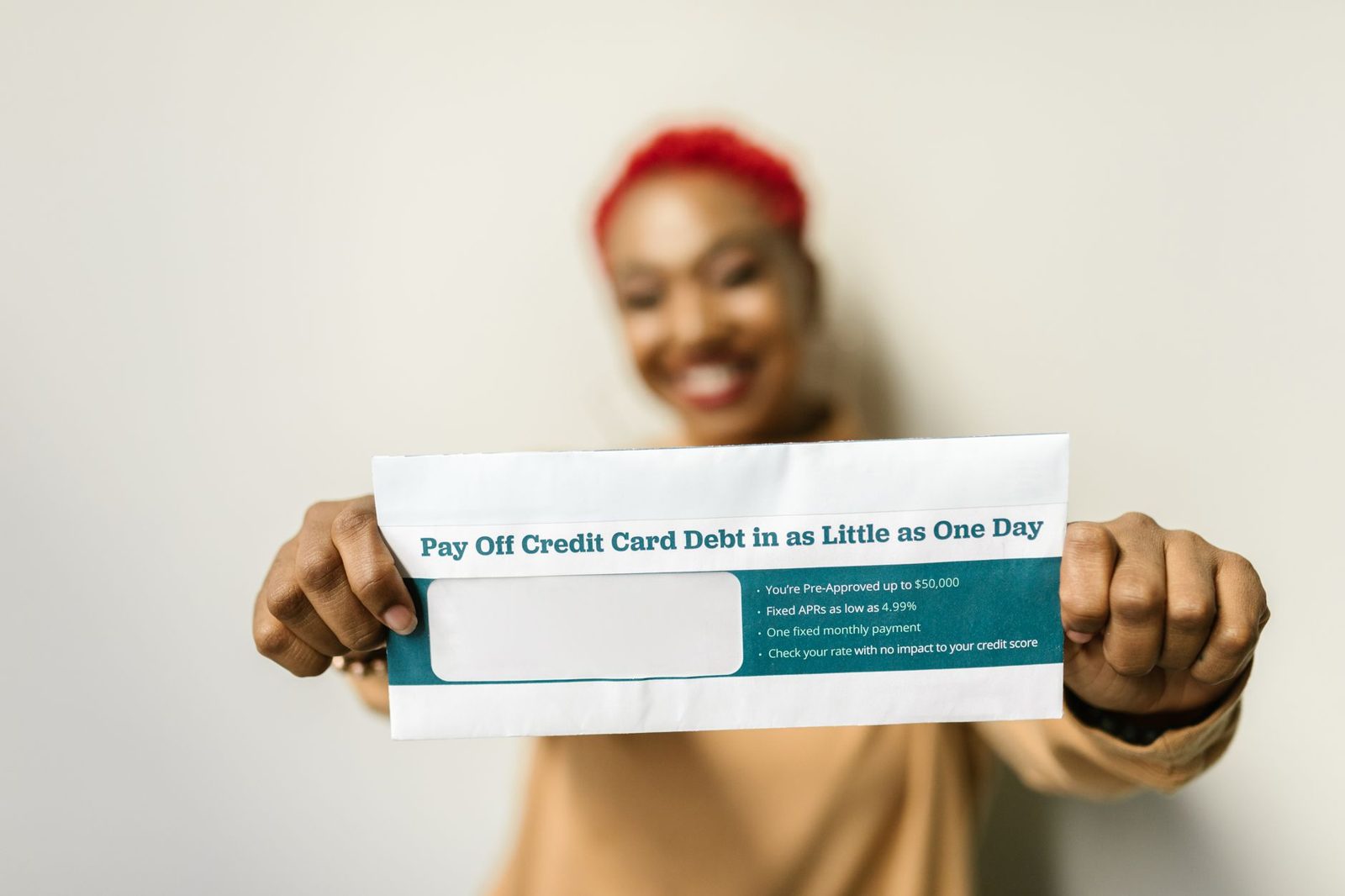 Person reviewing debt payoff strategy to reduce monthly obligations and improve DTI before a mortgage application.