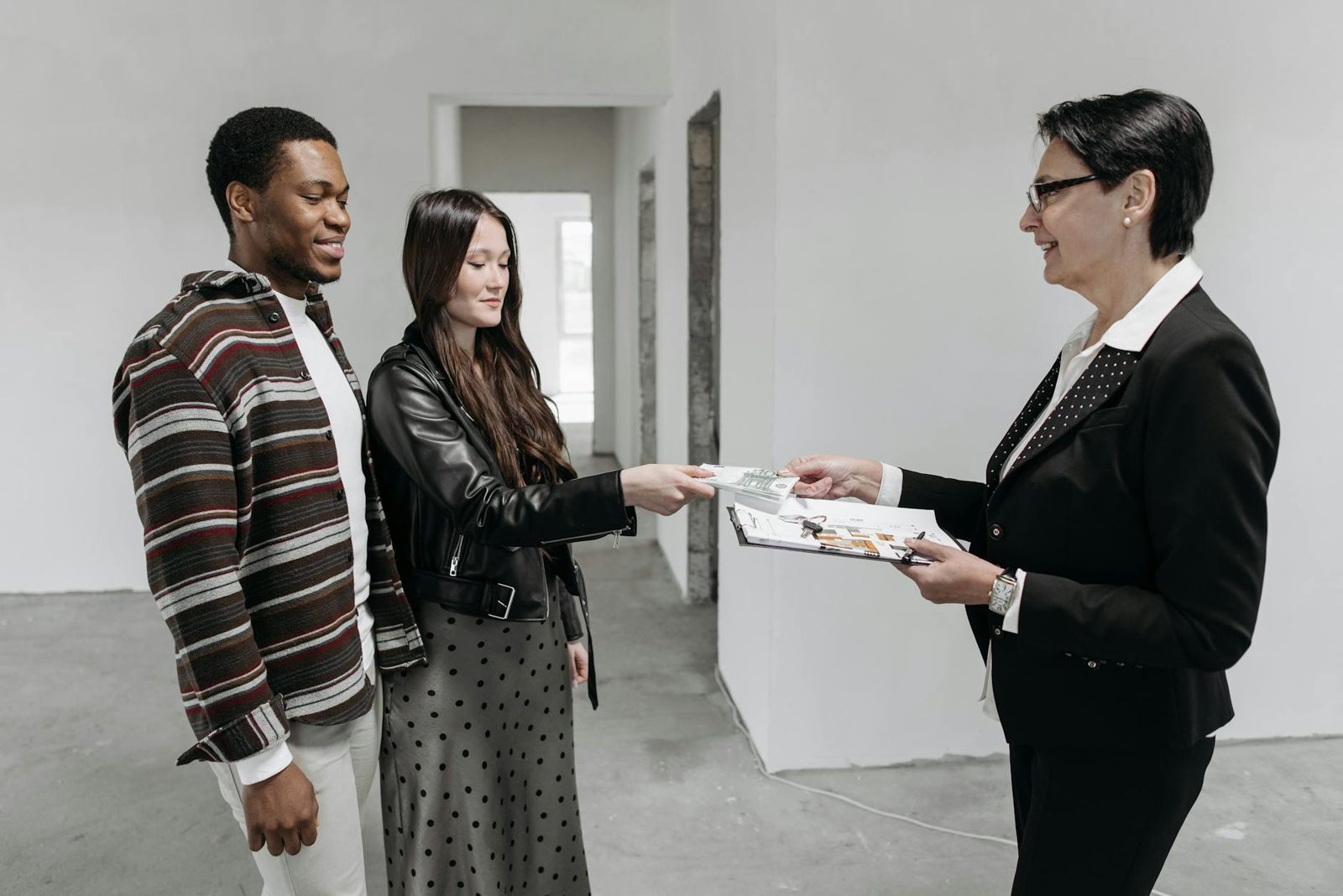 A listing agent reviewing the selling plan with homeowners — choosing the right pro and trusting their guidance.