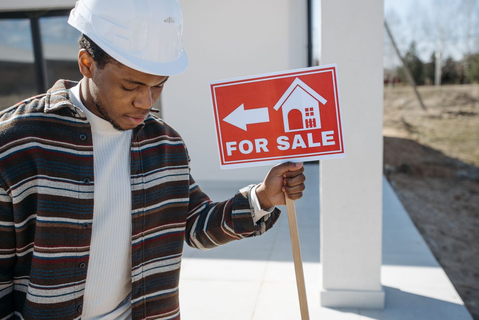 New construction home with sales office sign in front
