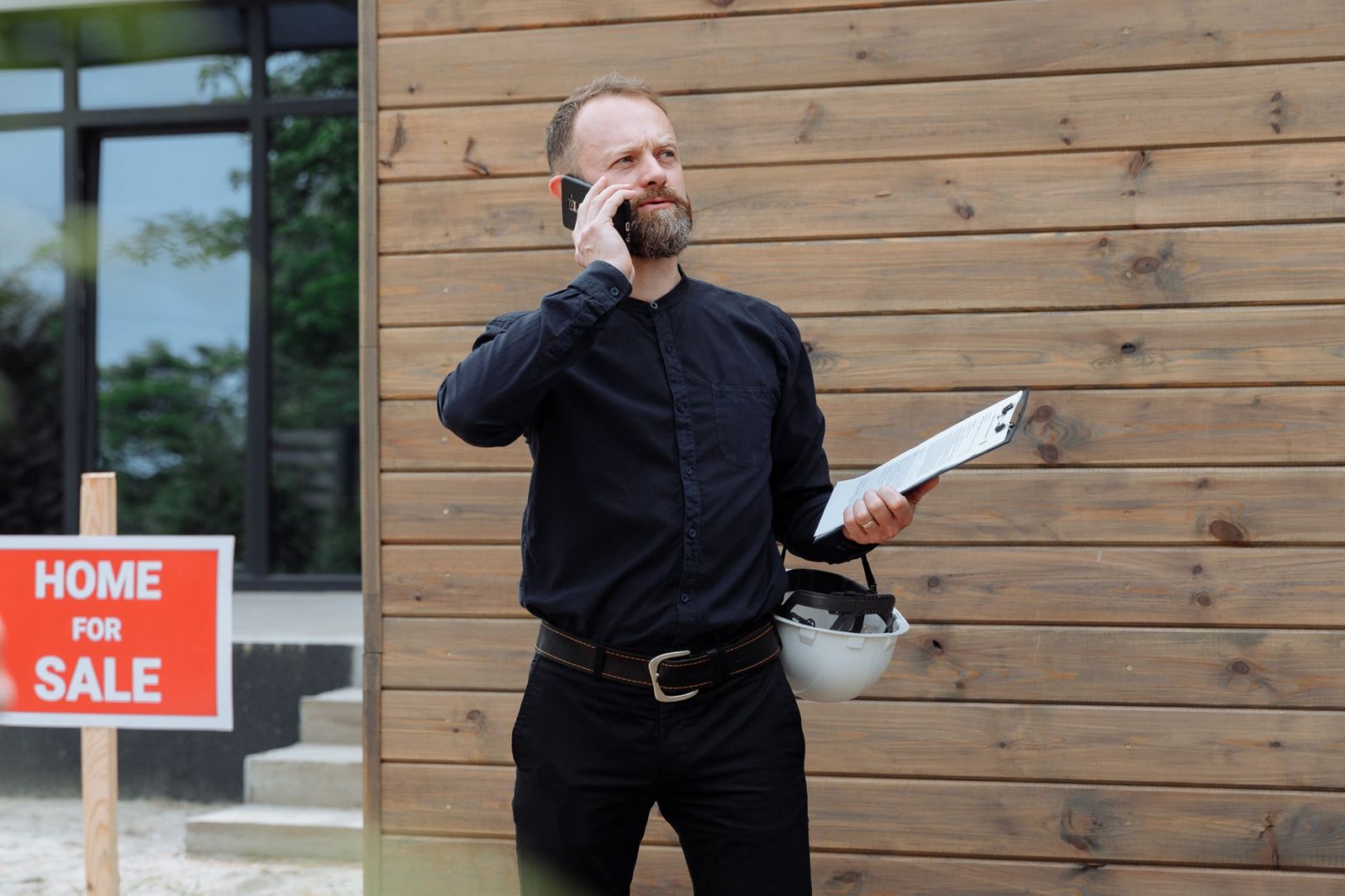 Real estate agent on phone while reviewing home offer documents