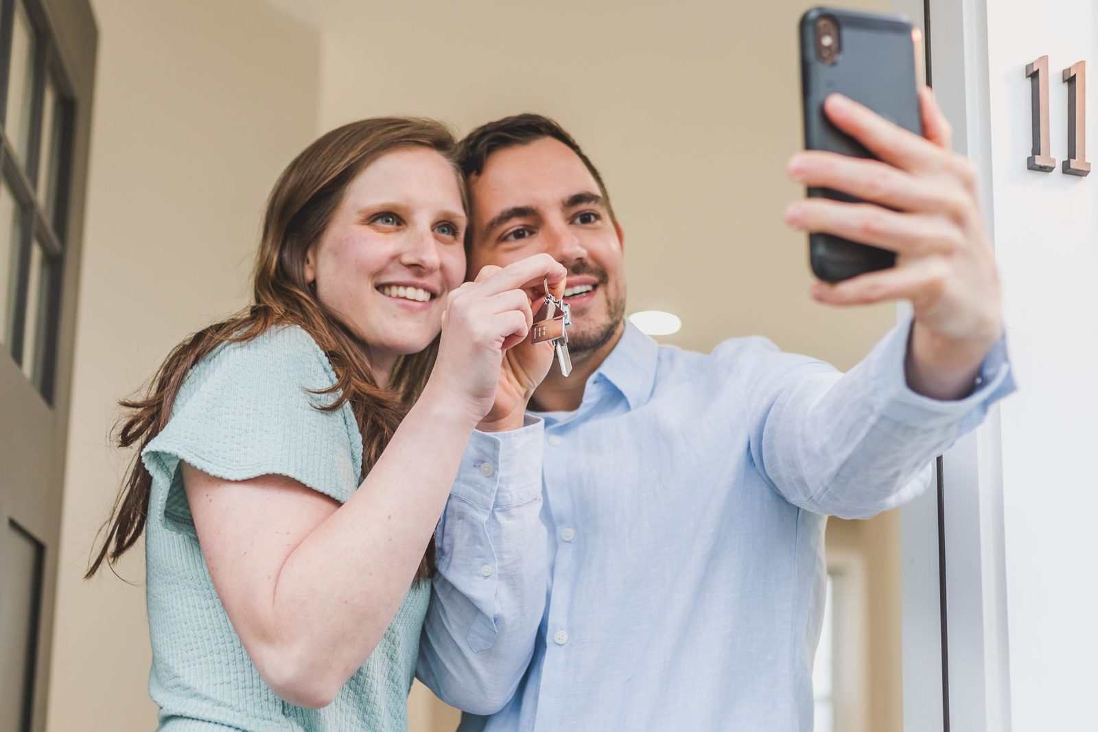Couple receiving keys at the front door of their new home
