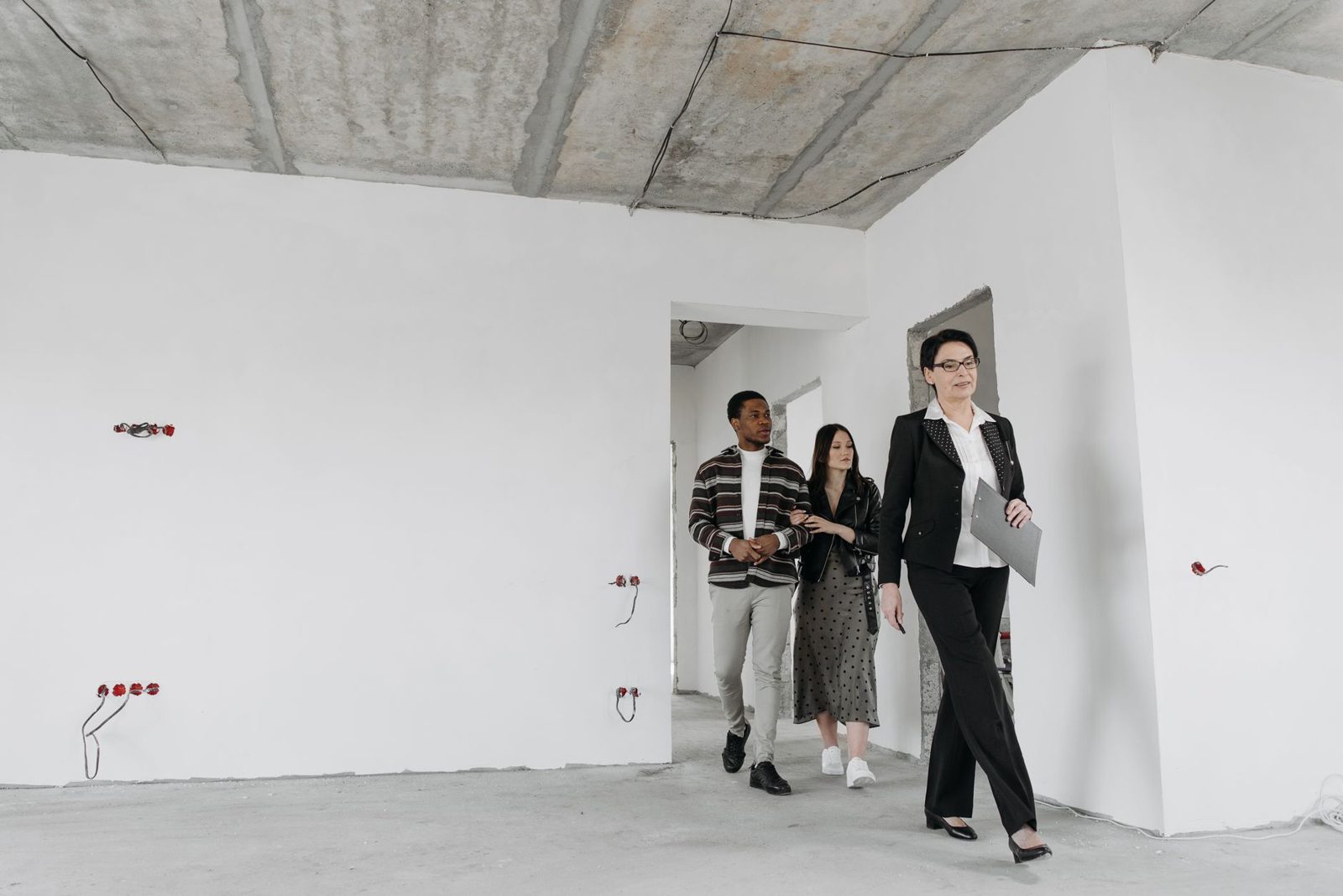 Homebuyers doing a final walkthrough of an empty house before closing