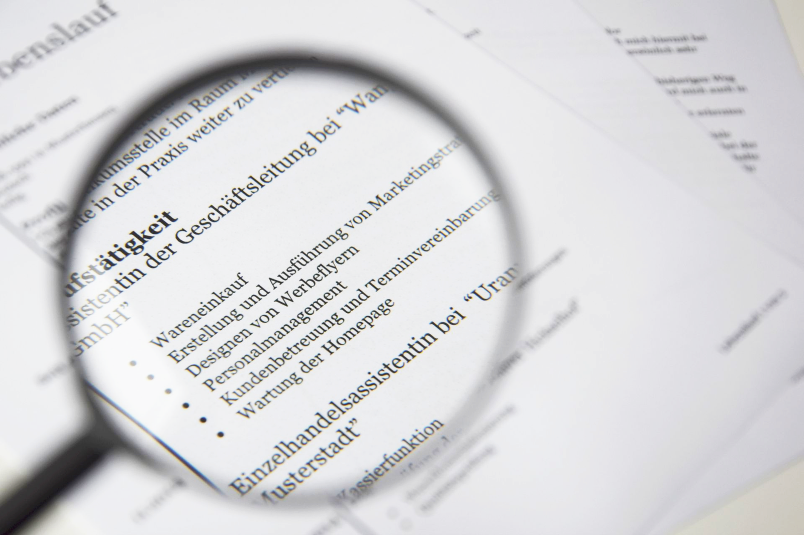 A magnifying glass held over printed text on a document