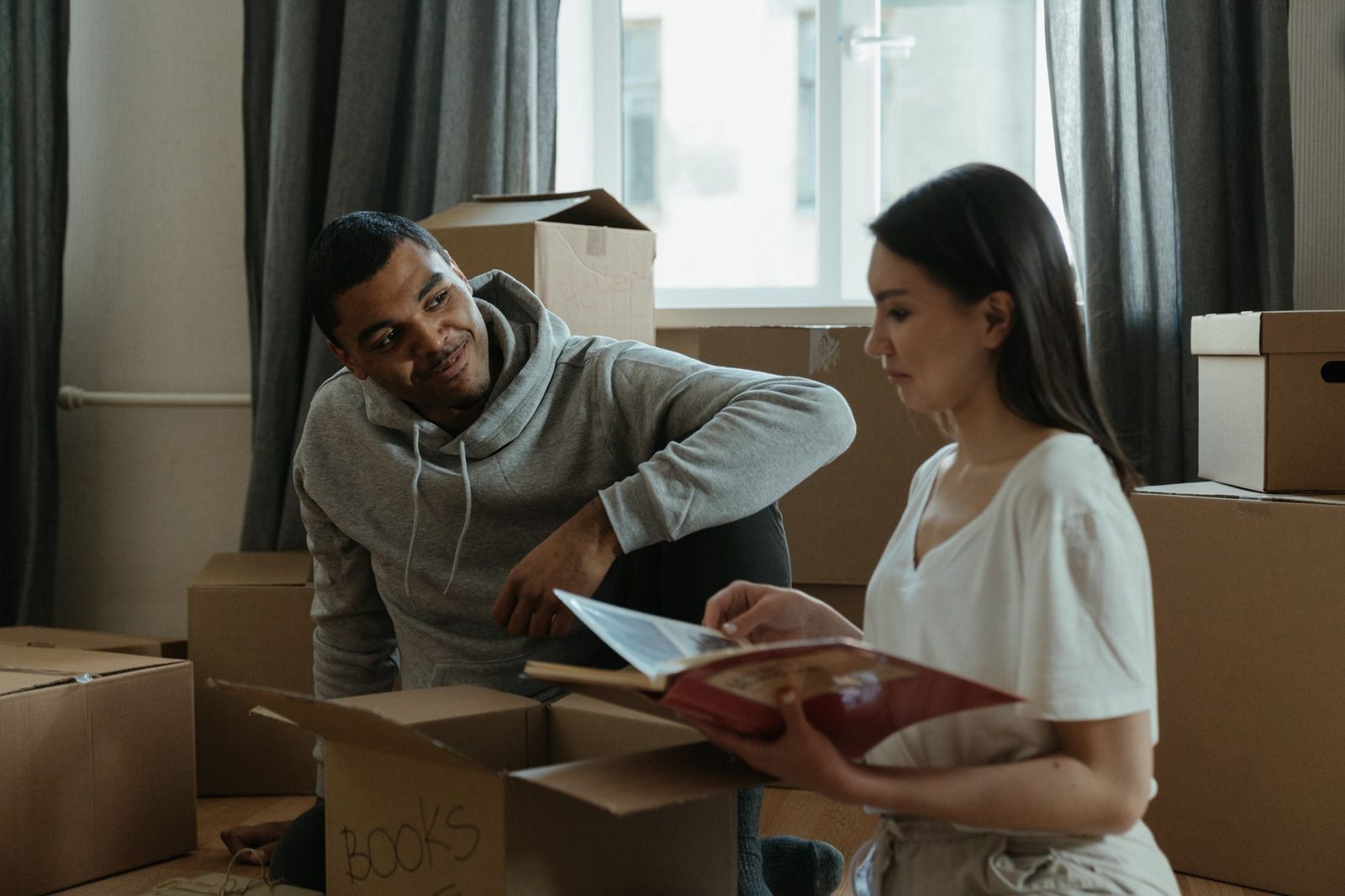Family with moving boxes representing a shorter homeownership timeline