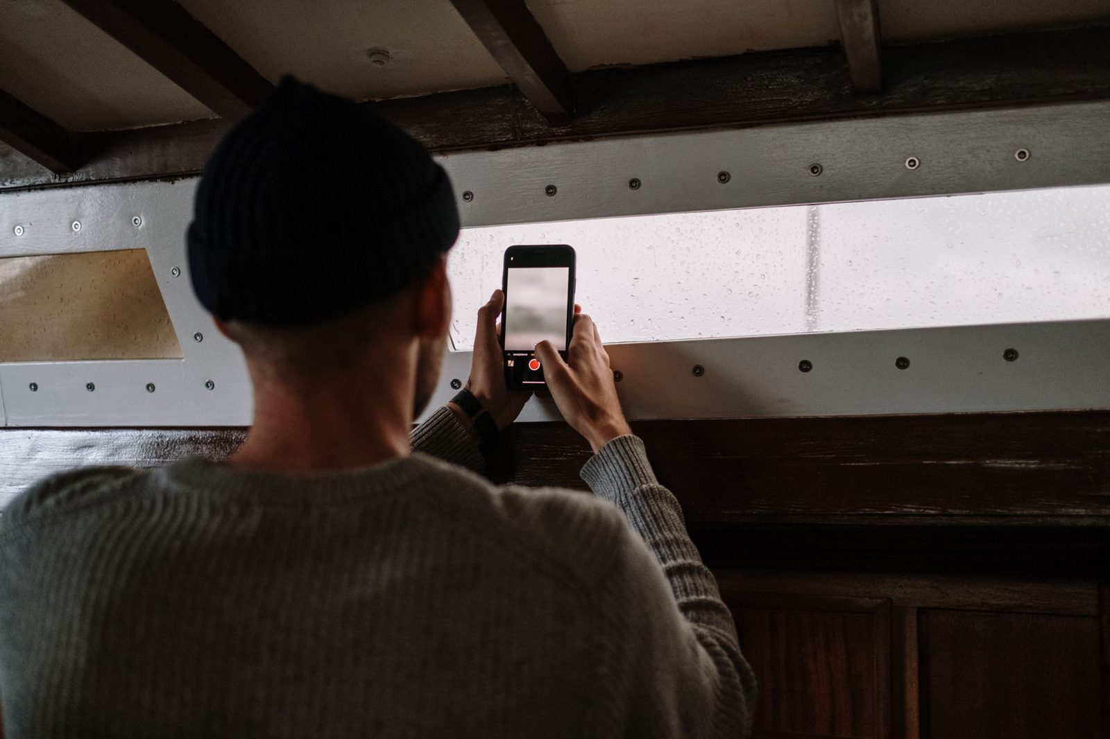Person documenting property damage with photos for an insurance claim