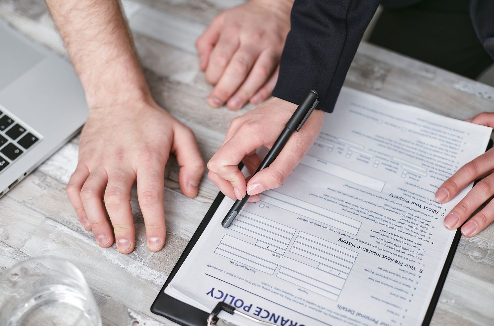 Close-up of a title insurance policy document with a pen resting on top
