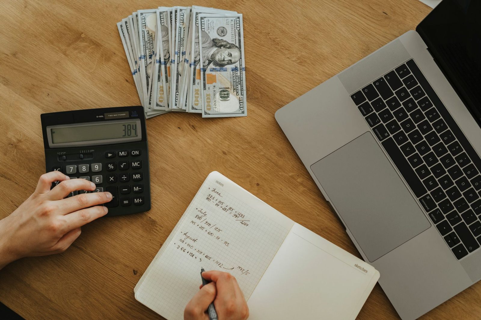 Person calculating mortgage payment scenarios and savings on a laptop