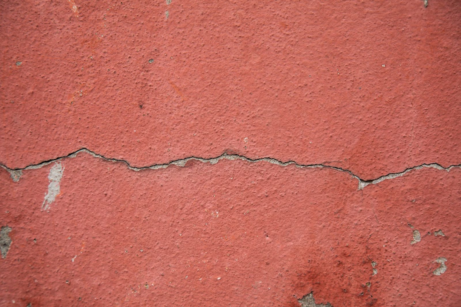 Foundation crack on an exterior wall representing water damage from poor drainage