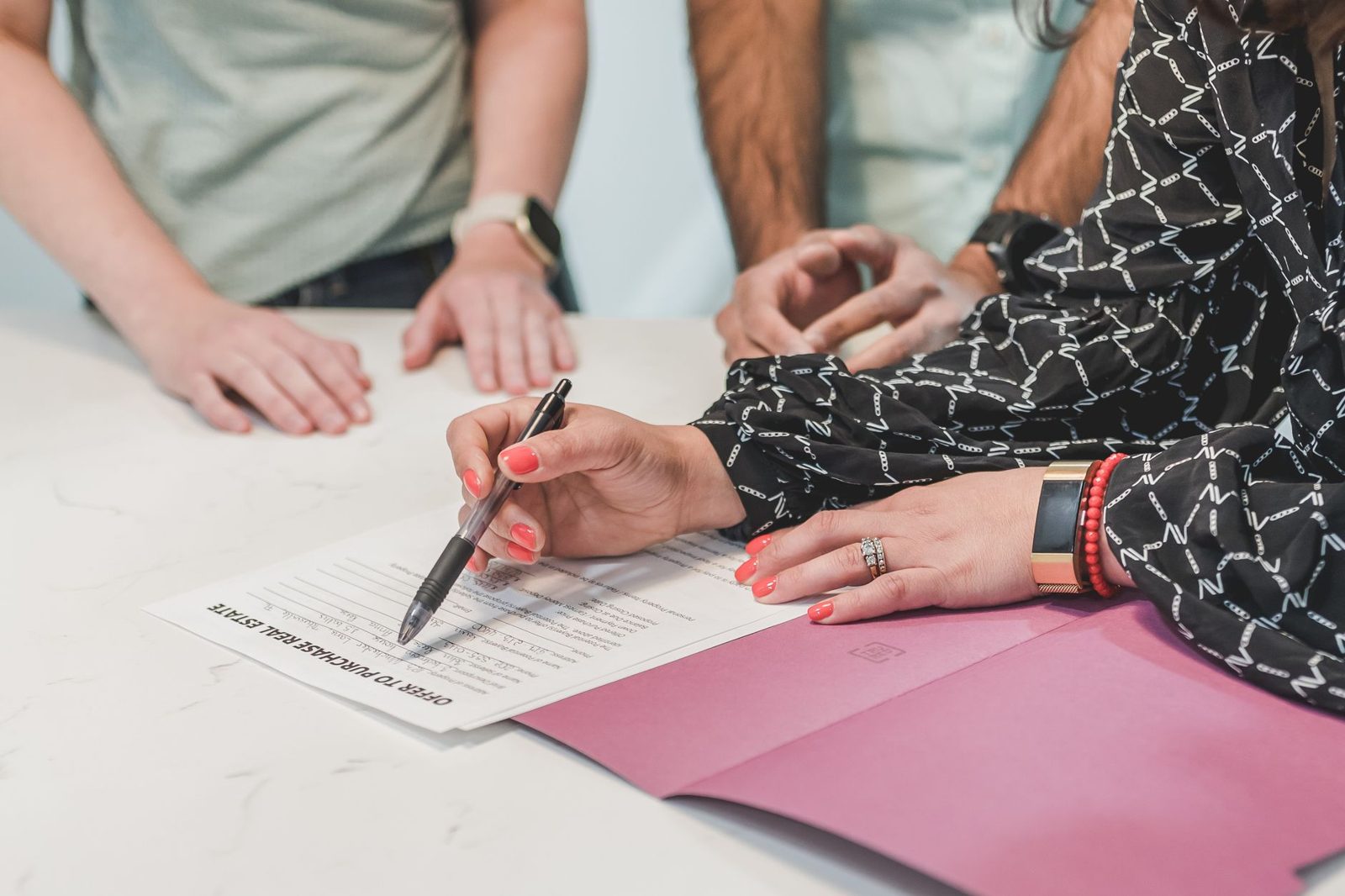 Buyer reviewing and signing a real estate contract with contingency terms