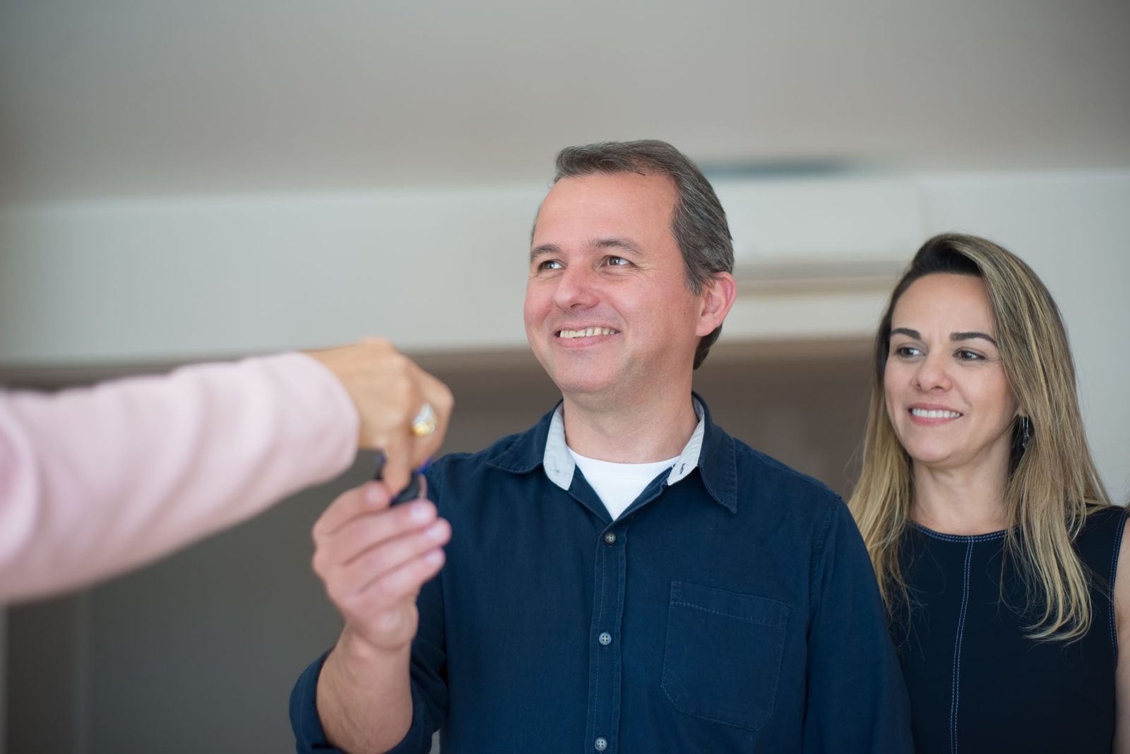 New homeowners receiving keys to their home at the front door