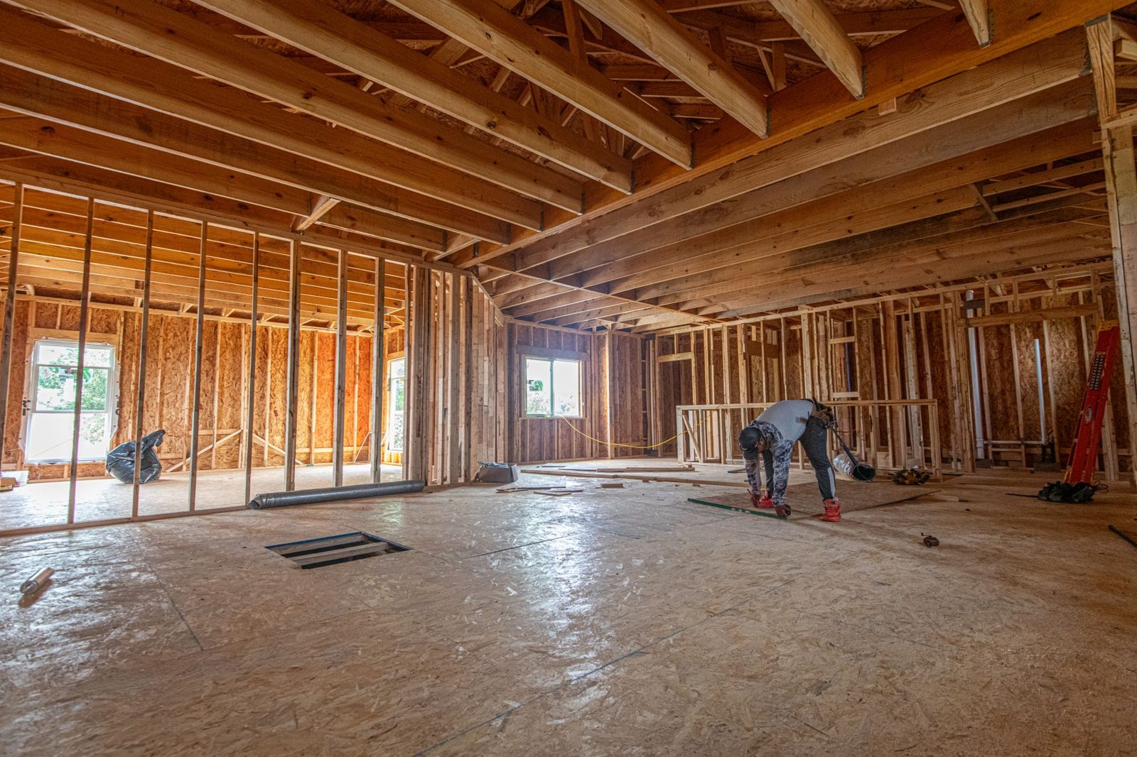 Inspector examining new construction framing before drywall