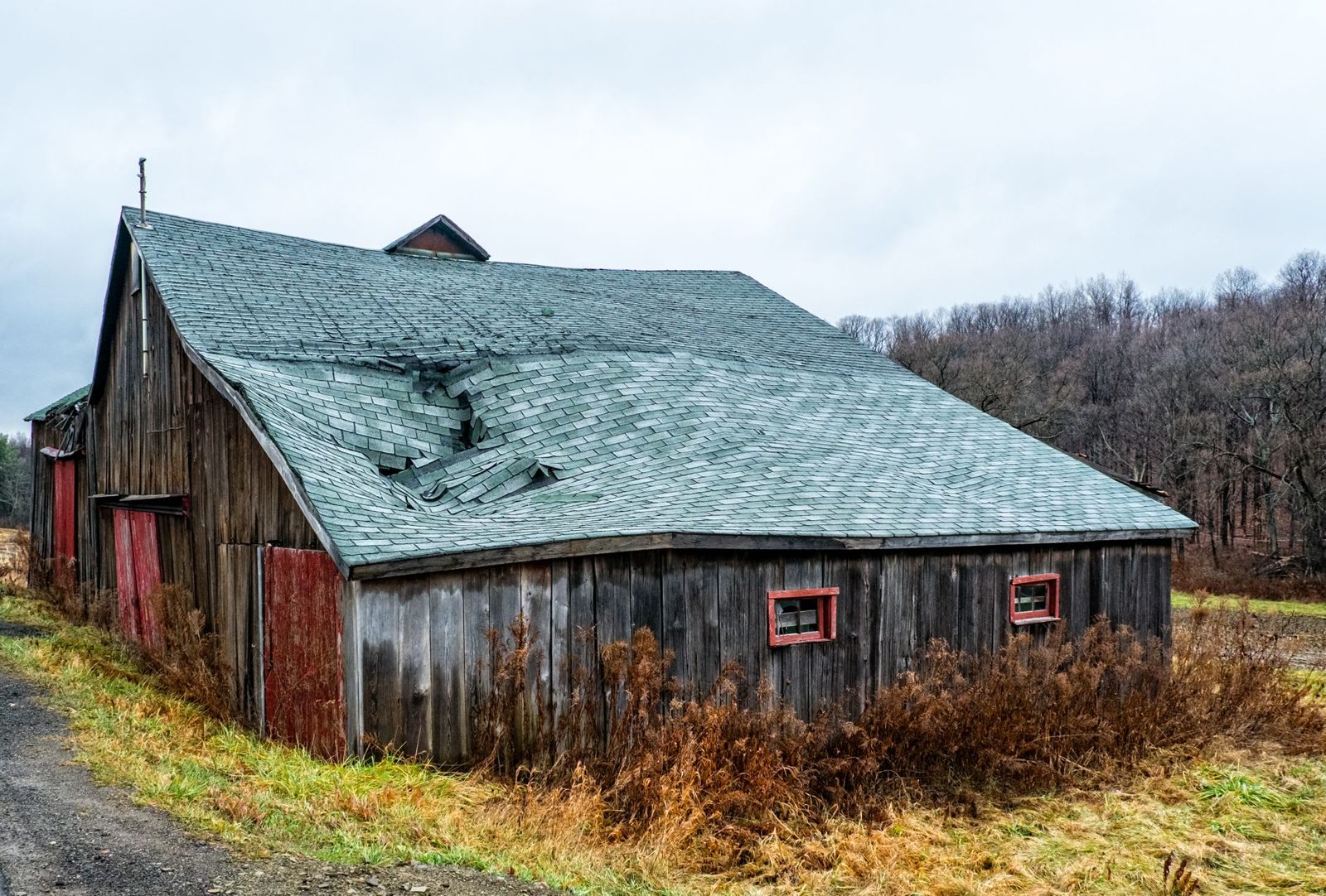 Roof with storm damage and missing shingles