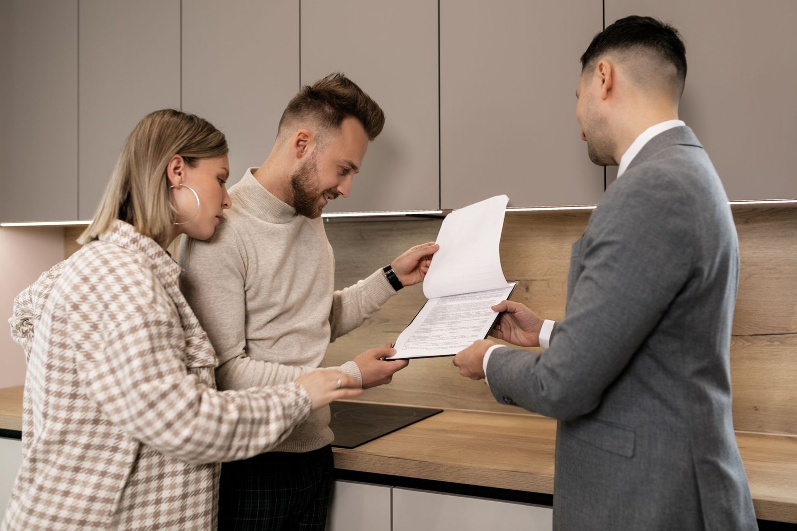 Couple reviewing a builder purchase contract with their agent